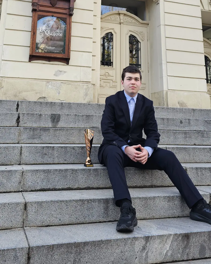 Dominik seated beside his trophy after placing third at the national SOČ competition